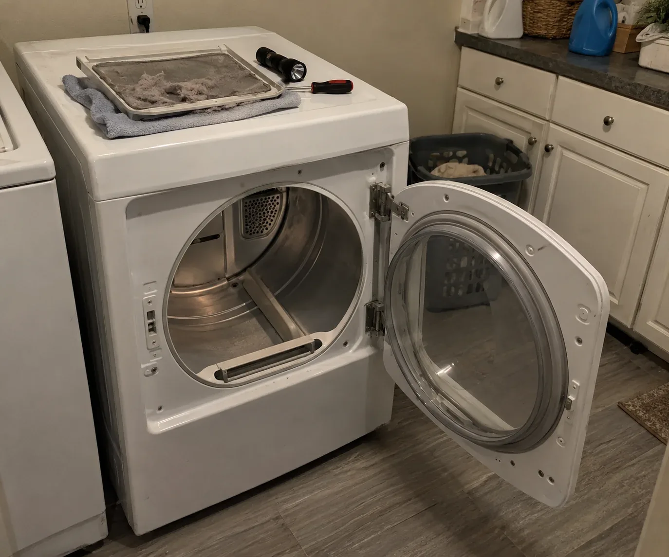 Residential clothes dryer undergoing repair inspection
